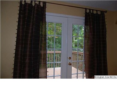 LOVELY FRENCH DOORS LEAD FROM THE DINING ROOM TO A
