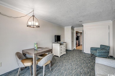 Dining area featuring crown molding, dark carpet, 