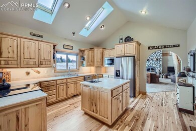 Kitchen featuring a kitchen island, high vaulted c