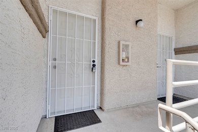 Doorway to property featuring stucco siding