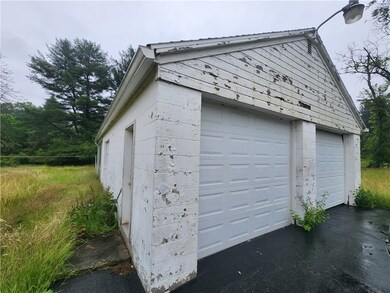 Primary 2 car garage with covered back patio leads