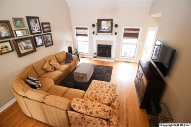 A VIEW OF THE TWO STORY GREAT ROOM WITH EXTENSIVE HARDWOODS!  THIS ROOM WILL HOLD YOUR BIG FURNITURE!