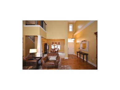 Entry and balcony overlooking gathering space