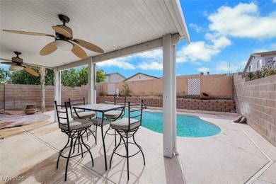 View of swimming pool featuring a patio, ceiling fan, and a fenced backyard