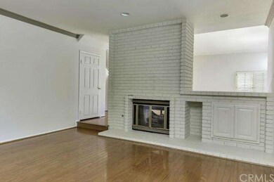 Two way fireplace separates formal and informal ar