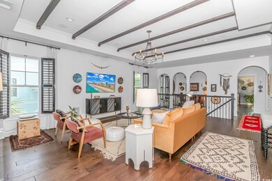 Living room with beamed ceiling, an inviting chand