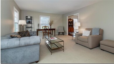The living room offers abundant seating and room f