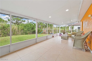 Sunroom / solarium featuring an outdoor hangout area and view of wooded area
