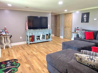 Living room featuring a barn door, ornamental mold