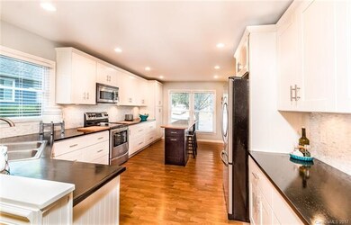Fully renovated kitchen with windows.
