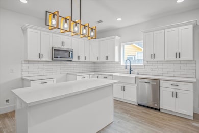 This modern kitchen features a breakfast bar, whit