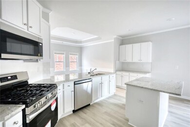 Kitchen with crown molding, appliances with stainl