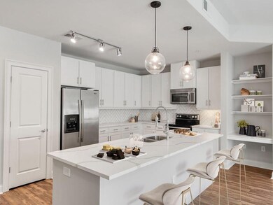 Kitchen featuring backsplash, white cabinets, a ki