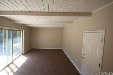 Family room has new carpet, open beam ceilings, ac