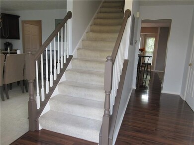 The foyer, with gleaming laminate flooring, welcom
