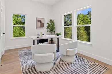 Office with plenty of natural light and light wood-style floors