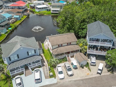 Aerial perspective of suburban area featuring a nearby body of water