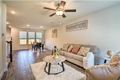Living area featuring dark wood-style floors, a c