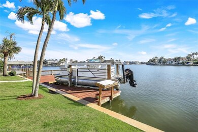 View of dock with a water view and a yard