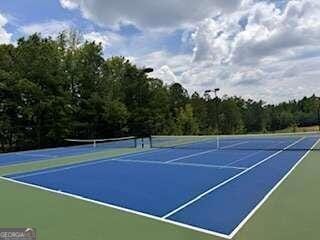 View of tennis court featuring community basketball court
