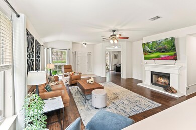 Living area featuring a warm lit fireplace, a cei