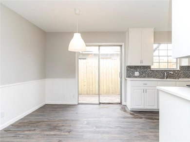 Kitchen with decorative light fixtures, dark wood