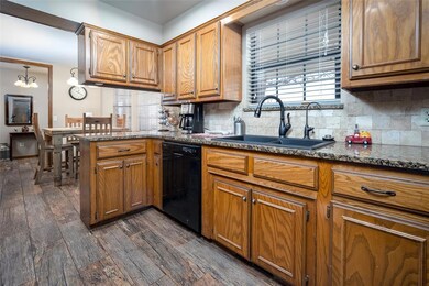 Kitchen with pendant lighting, sink, black dishwas