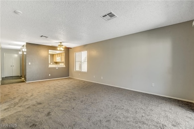 Unfurnished room with carpet floors, a ceiling fan