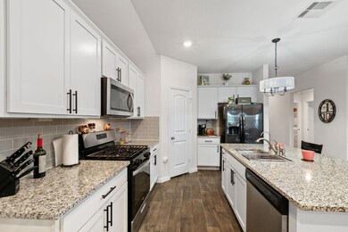 Kitchen with stainless steel appliances, a sink, 