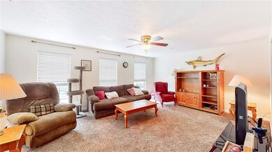 17'x15' living room has three large windows that p