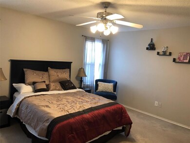 Carpeted bedroom featuring a textured ceiling and 