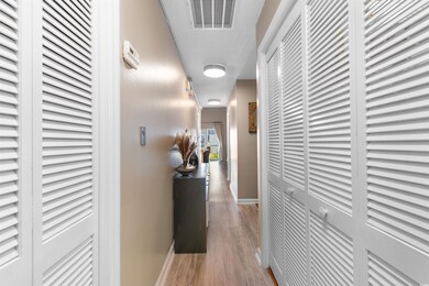 Hallway featuring baseboards and wood finished floors