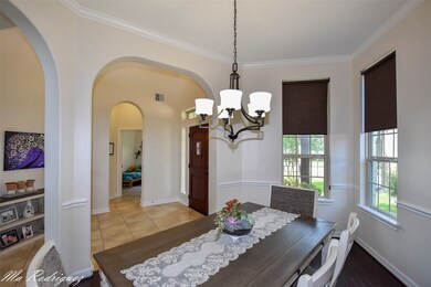 Beautiful arches and crown molding stands up on this beautiful formal dinning room.