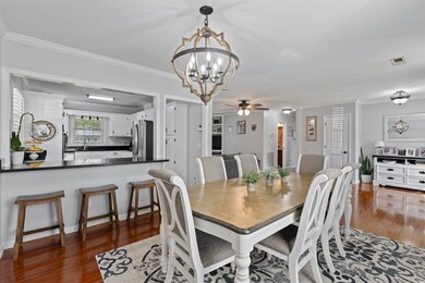 Dining space with a chandelier, wood finished floo
