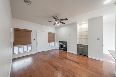 Unfurnished living room featuring wood-type floori
