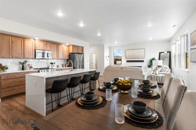 Kitchen featuring a center island with sink, appli
