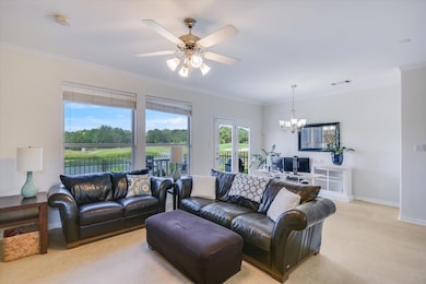 Living area featuring a chandelier, crown molding