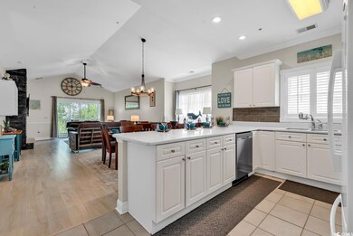 Kitchen with light countertops, a sink, a peninsul