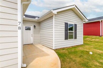 Entrance to property with a lawn