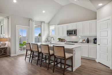 Kitchen in the Wimbledon home plan by Trophy Signature Homes – REPRESENTATIVE PHOTO
