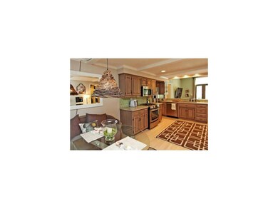 Green tiled backsplash accents the blond wood floo