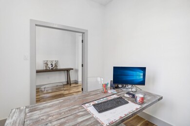 Home office with hardwood / wood-style floors