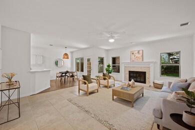 Living room featuring ceiling fan, light tile pat