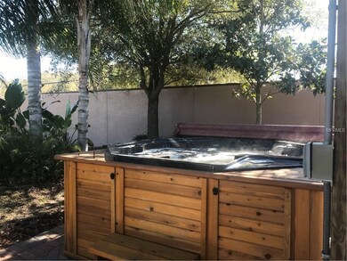Steps lead to jetted hot tub. South privacy wall r