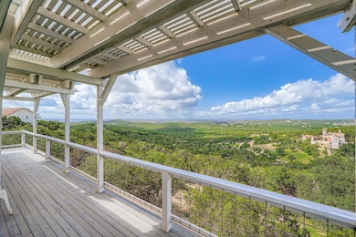 Wooden terrace featuring a forest view and a perg