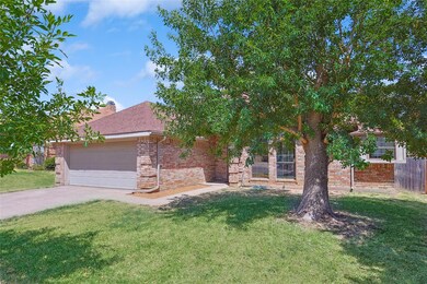 Obstructed view of property featuring a garage and a front lawn