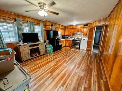 Kitchen with hardwood / wood-style flooring, stain