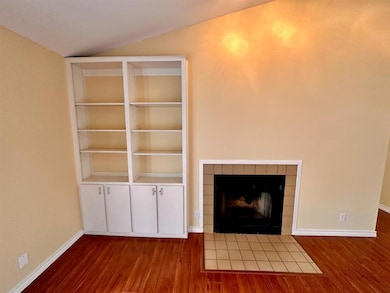 Unfurnished living room featuring a fireplace, wo