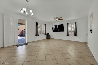 Spare room featuring a chandelier, ceiling fan, an