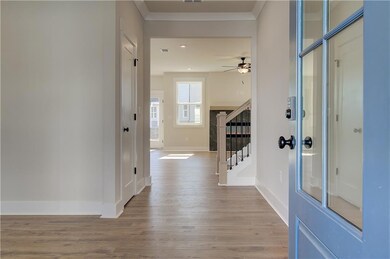 Foyer featuring wood finished floors, ornamental m